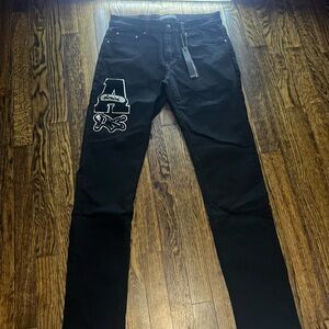 AMIRI Black Skinny Jeans with White and Pink Patch